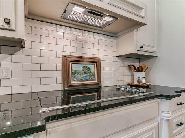 14210 Jack Rabbit Trl, Arcadia, OK 73007 - kitchen with dark countertops, decorative backsplash, white cabinets, and range hood