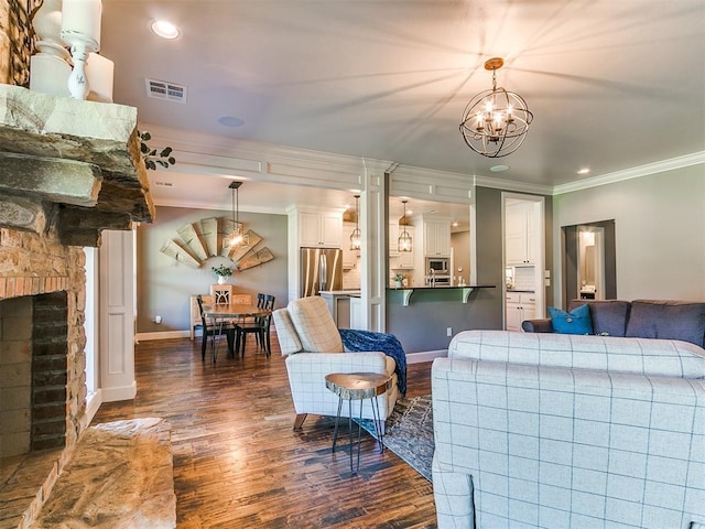 14210 Jack Rabbit Trl, Arcadia, OK 73007 - living room with crown molding, dark wood-style floors, a chandelier, baseboards, and a fireplace