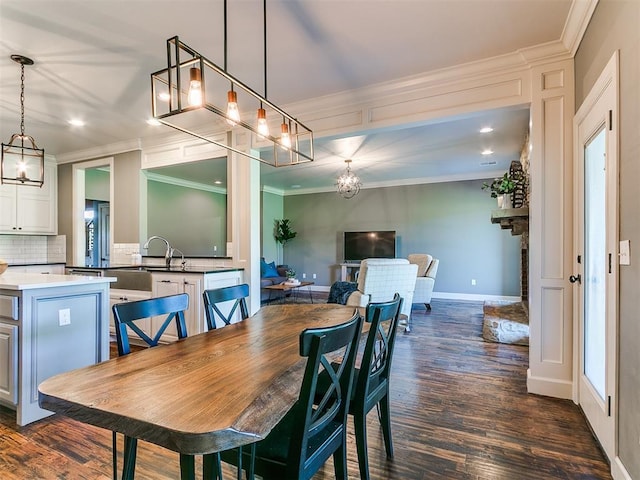 14210 Jack Rabbit Trl, Arcadia, OK 73007 - dining room featuring a chandelier, dark wood-style floors, crown molding, recessed lighting, and baseboards