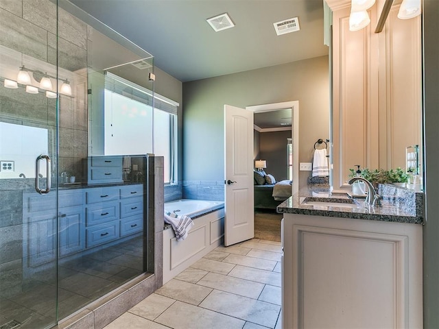 14210 Jack Rabbit Trl, Arcadia, OK 73007 - bathroom featuring vanity, a bath, a shower stall, ensuite bathroom, and tile patterned floors