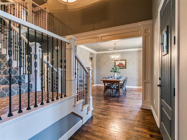 14210 Jack Rabbit Trl, Arcadia, OK 73007 - entrance foyer featuring a chandelier, stairs, dark wood-type flooring, crown molding, and baseboards