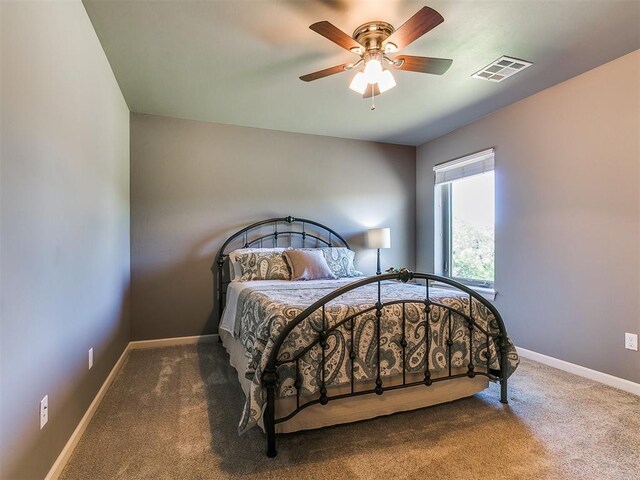 14210 Jack Rabbit Trl, Arcadia, OK 73007 - bedroom with carpet floors, baseboards, and ceiling fan