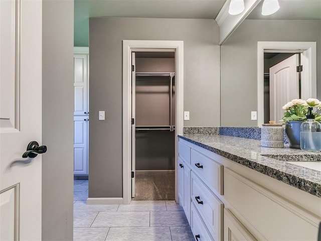 14210 Jack Rabbit Trl, Arcadia, OK 73007 - bathroom featuring vanity, baseboards, and tile patterned flooring