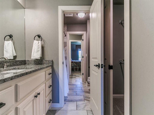 14210 Jack Rabbit Trl, Arcadia, OK 73007 - bathroom with vanity, baseboards, and toilet