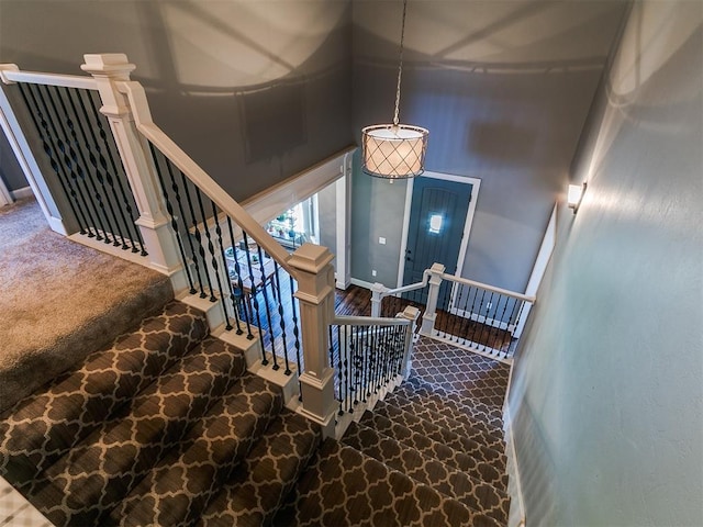 14210 Jack Rabbit Trl, Arcadia, OK 73007 - stairway featuring a towering ceiling, carpet flooring, and baseboards