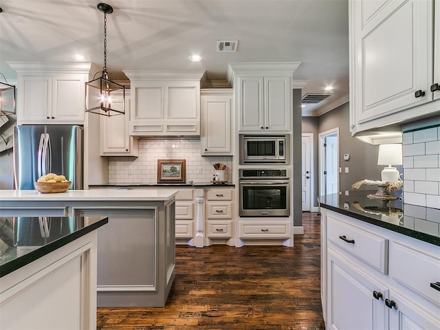 14210 Jack Rabbit Trl, Arcadia, OK 73007 - kitchen featuring stainless steel appliances, tasteful backsplash, ornamental molding, white cabinets, and dark wood-style floors