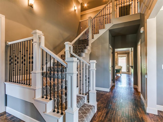 14210 Jack Rabbit Trl, Arcadia, OK 73007 - stairs featuring wood finished floors, a towering ceiling, and ornamental molding