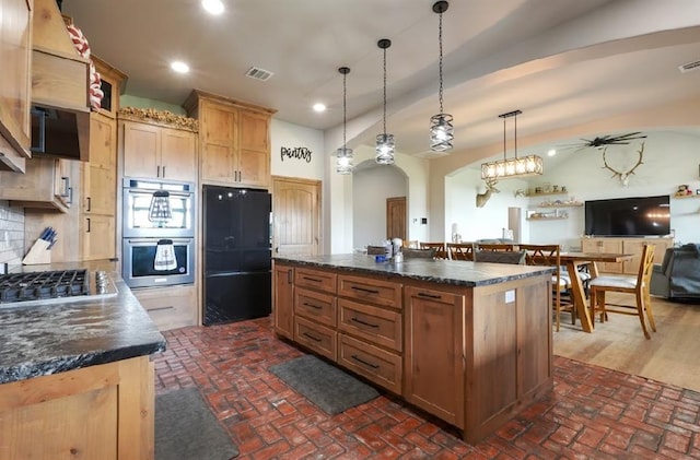 9027 Ns 3500th Rd, Prague, OK 74864 - kitchen featuring appliances with stainless steel finishes, dark countertops, brick floors, and recessed lighting