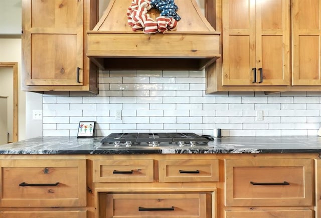 9027 Ns 3500th Rd, Prague, OK 74864 - kitchen featuring custom range hood, tasteful backsplash, stainless steel gas cooktop, and dark stone counters