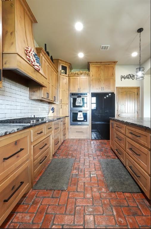 9027 Ns 3500th Rd, Prague, OK 74864 - kitchen with brick flooring, recessed lighting, decorative backsplash, stainless steel appliances, and premium range hood