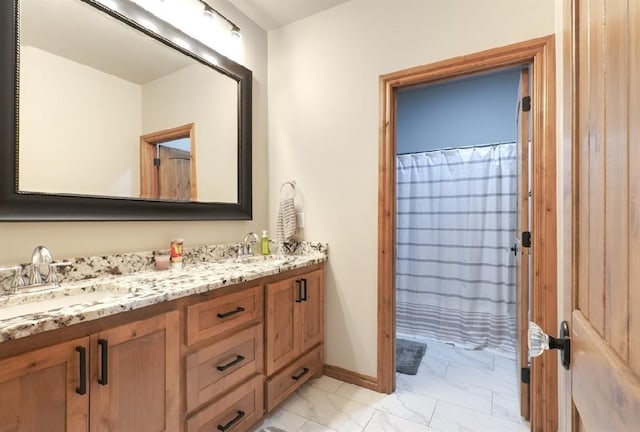 9027 Ns 3500th Rd, Prague, OK 74864 - bathroom featuring marble look tile flooring, double vanity, and baseboards
