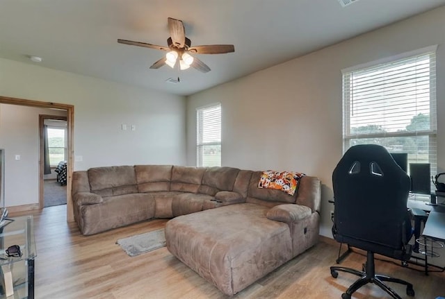 9027 Ns 3500th Rd, Prague, OK 74864 - living room with light wood-style floors, healthy amount of natural light, a ceiling fan, and a desk