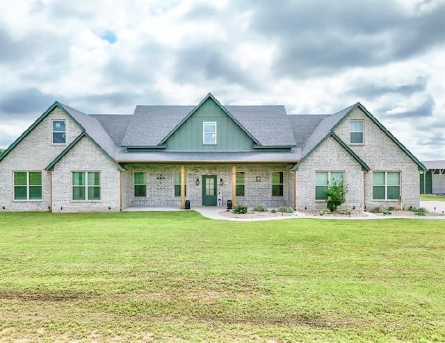 9027 Ns 3500th Rd, Prague, OK 74864 - view of front of home with board and batten siding, brick siding, and a front lawn