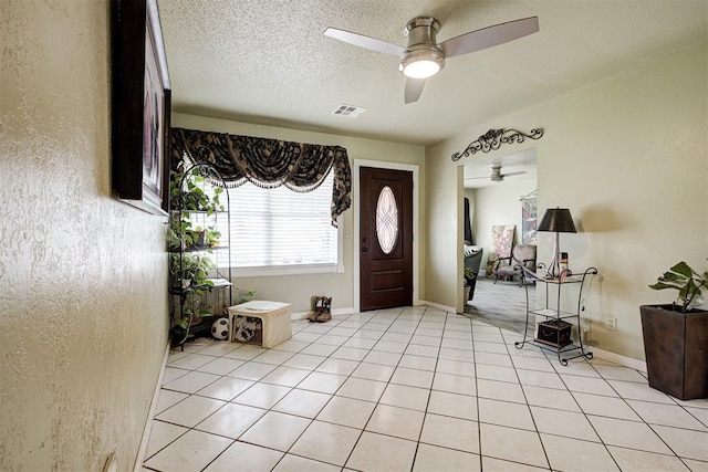 3117 Lazy Ln, Del City, OK 73115 - entrance foyer featuring ceiling fan, a textured ceiling, light tile patterned floors, and baseboards