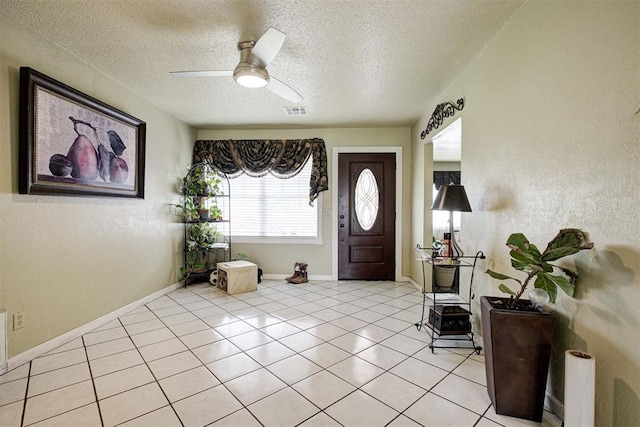 3117 Lazy Ln, Del City, OK 73115 - foyer entrance with a textured ceiling, a ceiling fan, light tile patterned flooring, and baseboards