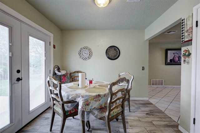 3117 Lazy Ln, Del City, OK 73115 - dining area featuring a textured ceiling and light wood-style flooring