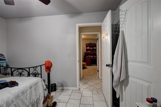 3117 Lazy Ln, Del City, OK 73115 - bedroom with a textured ceiling, a ceiling fan, and baseboards
