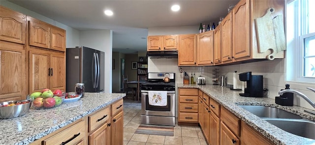 36797 N 56th Hwy, Okemah, OK 74859 - kitchen with freestanding refrigerator, gas range, a sink, under cabinet range hood, and tasteful backsplash