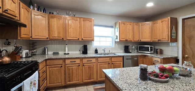 36797 N 56th Hwy, Okemah, OK 74859 - kitchen featuring stainless steel appliances, a sink, backsplash, light stone counters, and under cabinet range hood