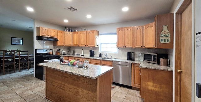 36797 N 56th Hwy, Okemah, OK 74859 - kitchen with appliances with stainless steel finishes, tasteful backsplash, light tile patterned floors, under cabinet range hood, and a sink
