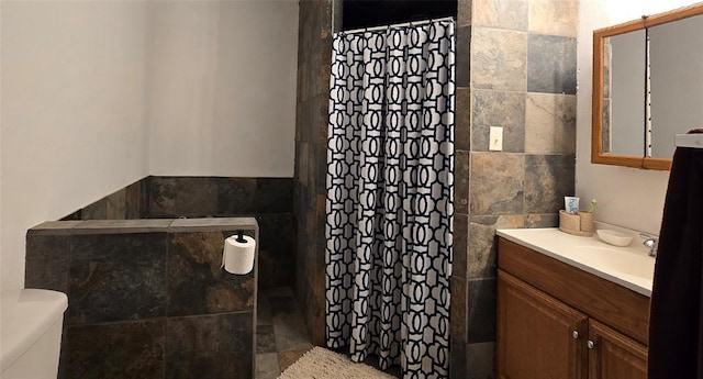 36797 N 56th Hwy, Okemah, OK 74859 - bathroom with tile walls, vanity, toilet, and a shower with curtain