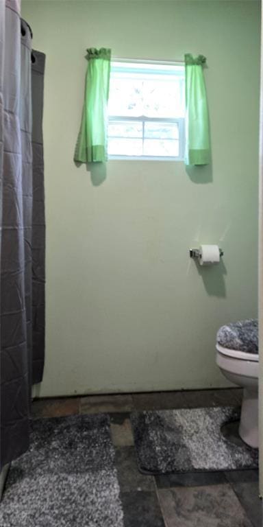 36797 N 56th Hwy, Okemah, OK 74859 - full bathroom featuring toilet and a shower with curtain