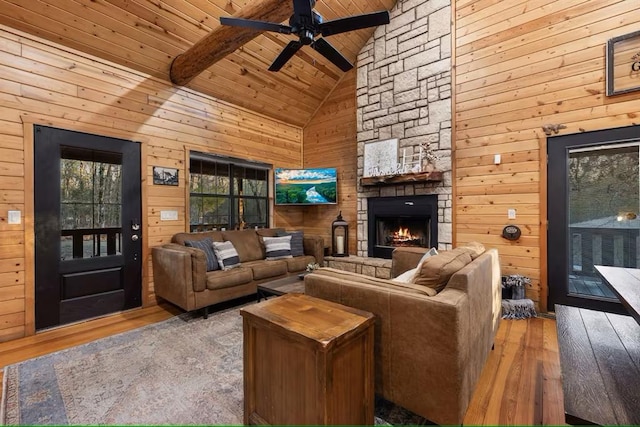 173 Alexis Ln, Broken Bow, OK 74728 - living room featuring wood ceiling with exposed beams, hardwood / wood-style floors, high vaulted ceiling, ceiling fan, and wood walls