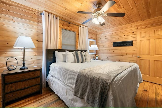 173 Alexis Ln, Broken Bow, OK 74728 - bedroom with wooden ceiling, wood walls, wood-type flooring, and ceiling fan