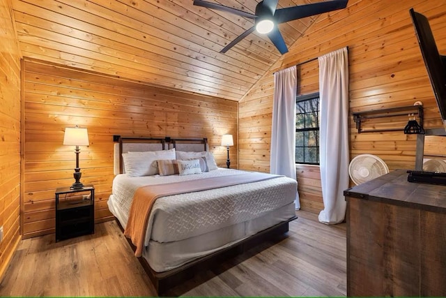 173 Alexis Ln, Broken Bow, OK 74728 - bedroom with vaulted ceiling, wooden walls, wood finished floors, wooden ceiling, and ceiling fan