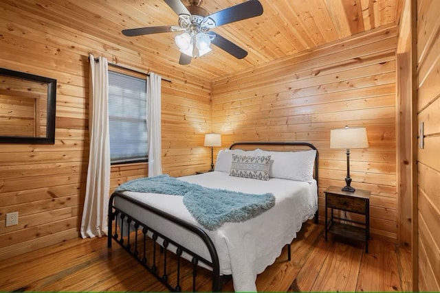 173 Alexis Ln, Broken Bow, OK 74728 - bedroom featuring wood-type flooring, wooden walls, a ceiling fan, and wood ceiling