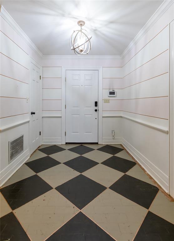 1301 W C Ave, Elk City, OK 73644 - foyer with a chandelier, ornamental molding, and tile patterned floors