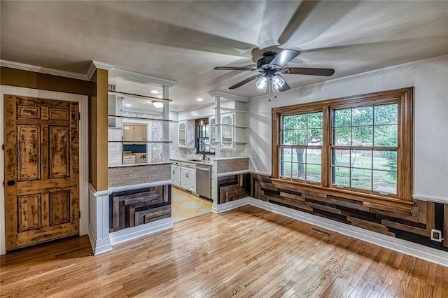 1301 W C Ave, Elk City, OK 73644 - kitchen with light wood finished floors, dishwasher, crown molding, ceiling fan, and glass insert cabinets