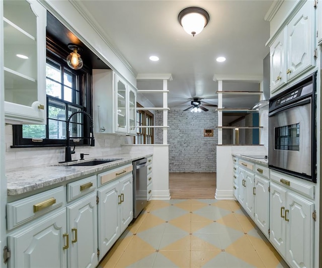 1301 W C Ave, Elk City, OK 73644 - kitchen with appliances with stainless steel finishes, a sink, a ceiling fan, white cabinets, and glass insert cabinets