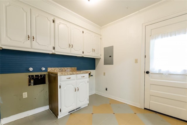 1301 W C Ave, Elk City, OK 73644 - washroom featuring cabinet space, electric panel, baseboards, washer hookup, and crown molding