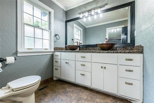 1301 W C Ave, Elk City, OK 73644 - full bathroom featuring a textured wall, crown molding, double vanity, toilet, and baseboards