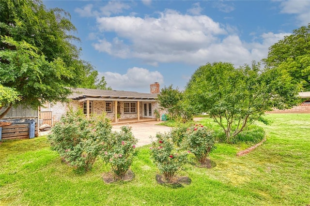 1301 W C Ave, Elk City, OK 73644 - back of property with a chimney, a patio, and brick siding