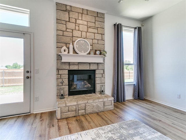 16020 Panther Way, Edmond, OK 73013 - unfurnished living room with wood finished floors, healthy amount of natural light, and a fireplace