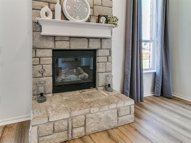 16020 Panther Way, Edmond, OK 73013 - detailed view of wood finished floors, baseboards, and a fireplace