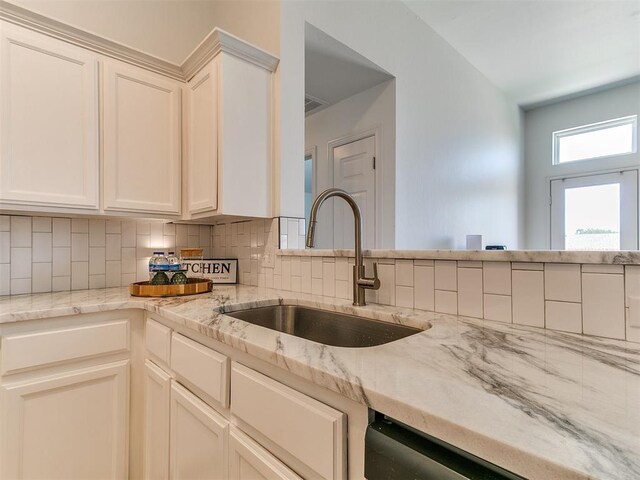16020 Panther Way, Edmond, OK 73013 - kitchen with a sink, tasteful backsplash, light stone countertops, and dishwasher