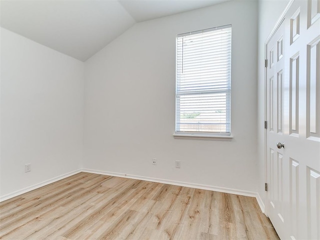 16020 Panther Way, Edmond, OK 73013 - unfurnished bedroom featuring wood finished floors, vaulted ceiling, and baseboards