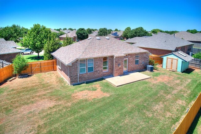16020 Panther Way, Edmond, OK 73013 - back of house featuring a patio, roof with shingles, and brick siding