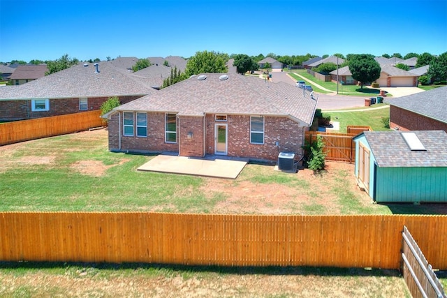 16020 Panther Way, Edmond, OK 73013 - back of property featuring central AC unit, a patio area, brick siding, and a residential view