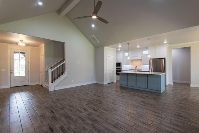 14601 Chambord Dr, Yukon, OK 73099 - kitchen featuring stainless steel appliances, dark wood-style floors, white cabinets, beamed ceiling, and recessed lighting