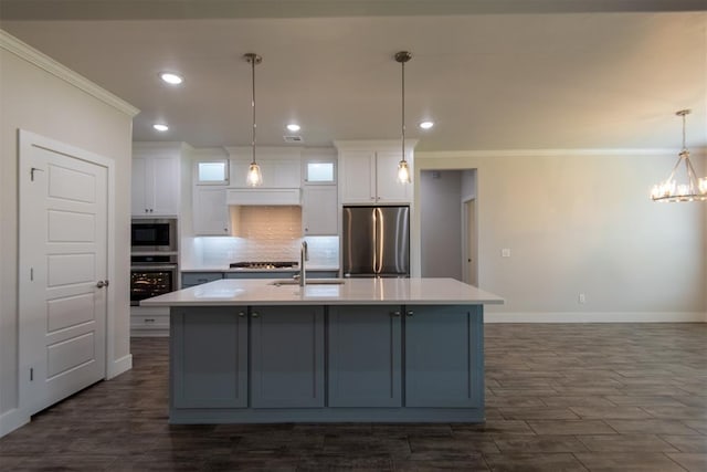 14601 Chambord Dr, Yukon, OK 73099 - kitchen with appliances with stainless steel finishes, a sink, crown molding, baseboards, and white cabinetry