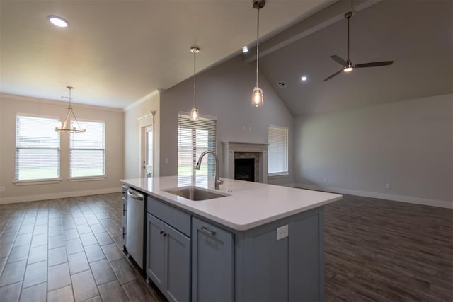 14601 Chambord Dr, Yukon, OK 73099 - kitchen featuring open floor plan, a sink, stainless steel dishwasher, a high end fireplace, and baseboards