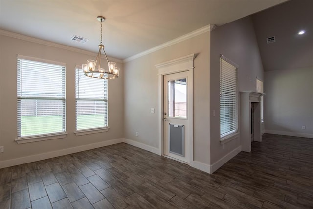 14601 Chambord Dr, Yukon, OK 73099 - unfurnished dining area featuring a chandelier, healthy amount of natural light, dark wood-type flooring, and crown molding