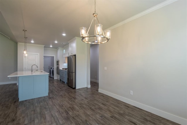 14601 Chambord Dr, Yukon, OK 73099 - kitchen with stainless steel appliances, a sink, baseboards, light countertops, and a chandelier