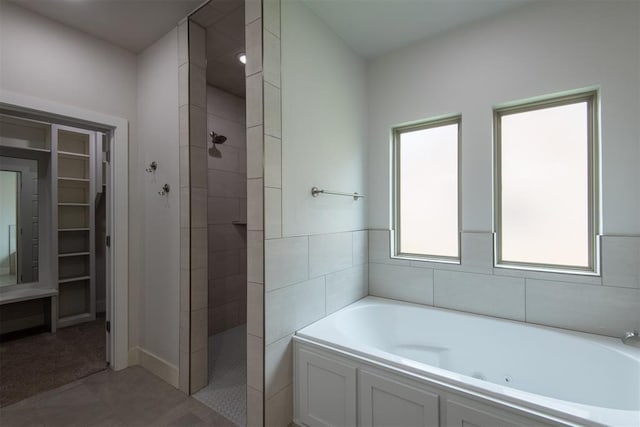 14601 Chambord Dr, Yukon, OK 73099 - full bathroom featuring a whirlpool tub, walk in shower, and a spacious closet