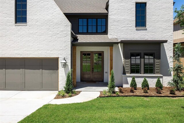 3817 Shady Hill Trl, Edmond, OK 73034 - doorway to property with french doors, concrete driveway, a lawn, and a garage