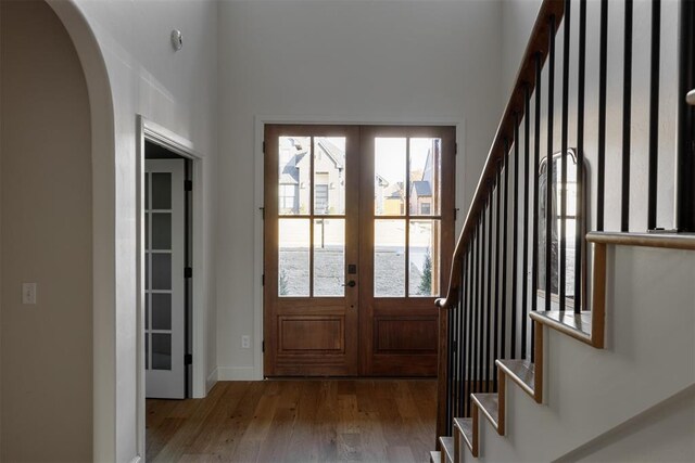 3817 Shady Hill Trl, Edmond, OK 73034 - entrance foyer featuring french doors, hardwood / wood-style flooring, arched walkways, stairs, and baseboards